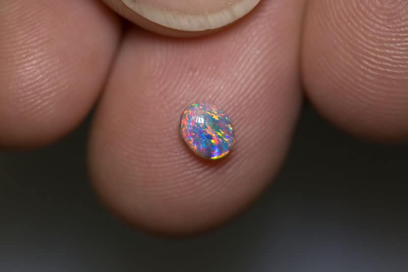 0.54 ct dark opal 5.5x4.5x3mm
