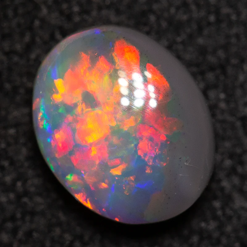 0.79 ct dark opal 7x5.7x3.2mm